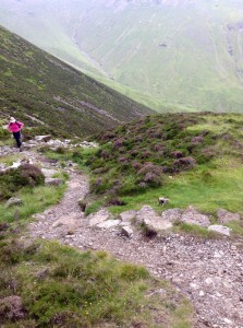 Hiker climbing up very slowly on Loft Beck