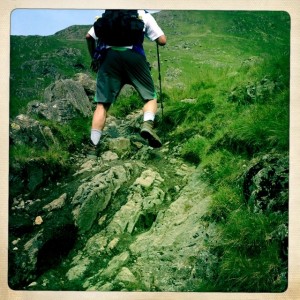 Tony climbs up steep rocky path