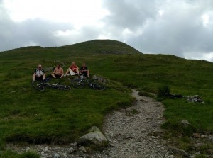 Mountain bikers mostly carrying their bikes up to ride down an old Roman Road.