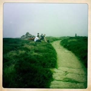 Third cairn with a group of young hikers heading the other way.